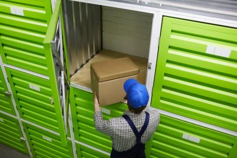 Man putting parcel in boxes Stock Photos