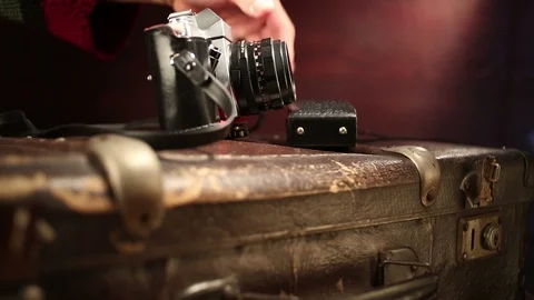 Man putting photo camera and light meter on suitcase. Video stock 91677341