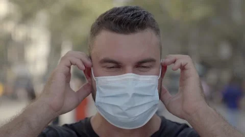 Man putting a protective face mask on Video stock 140104722