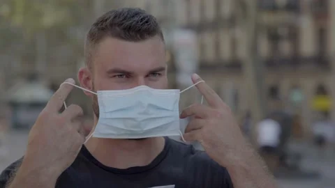 Man putting a protective face mask on Video stock 140104837