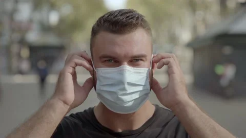 Man putting a protective face mask on Video stock 140104895