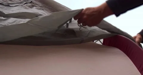 Man putting rain fly over tent Stock Footage 132345024