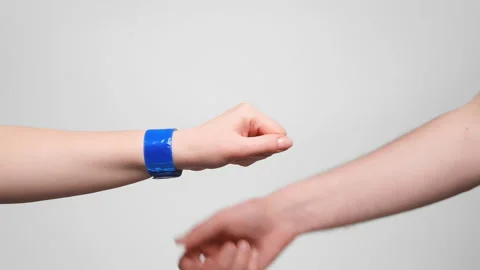 Man putting a reflective tape snap on woman's hand. 4k, slow motion. Vídeo Stock 238613298