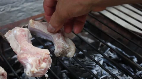 A man is putting ribs on a grill 스톡 동영상 131664570