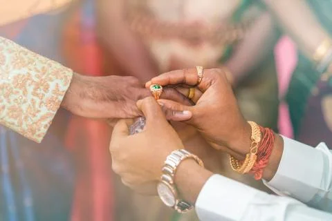 Man putting ring to another man indian wedding Stock Photos