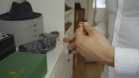 Man putting on a Rolex watch Stock Footage 129867495