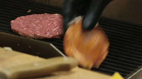 Man Putting Salami Slices on a Grill Stock Footage 71569211