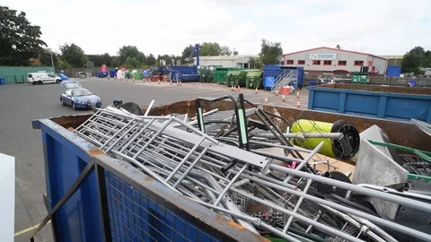 Man putting scrap metal into skip for recycling yorkshire united kingdom Stock Footage 114884170