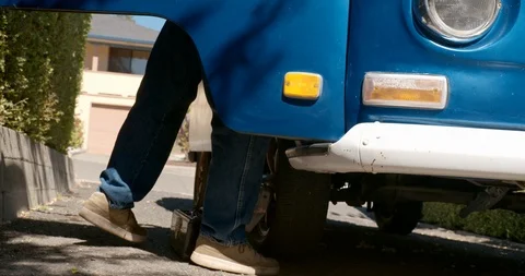 Man putting a screwdriver in a tool box by a van. Stock-Footage 88376033