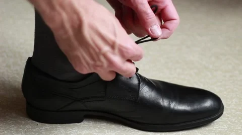 Man putting shoes on 스톡 동영상 64622053