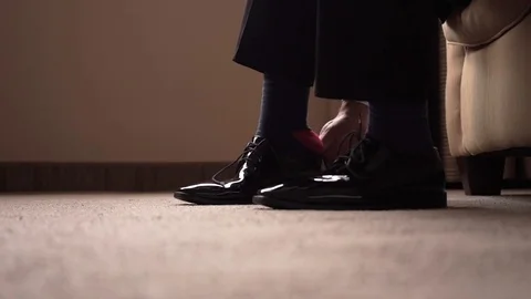 Man putting on shoes Stock Footage