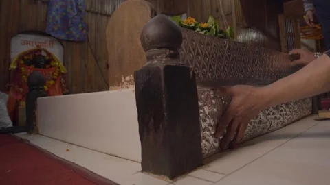 Man putting a silver plate on the temple Stock Footage 219611231