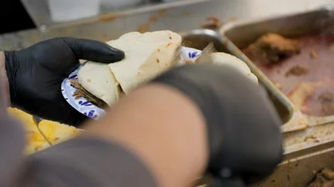Man Putting Some Birria Meat Into Hand Made Tortillas Stock Footage 342164337
