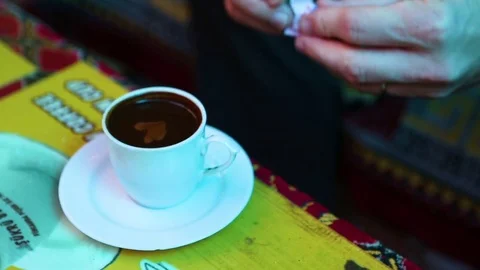 Man putting sugar cube in the black coffee Stock Footage 77451903