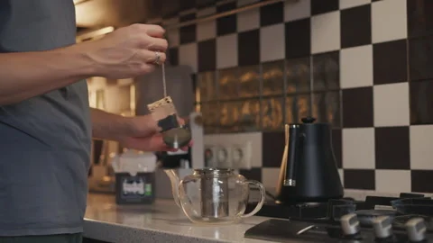 Man putting tea bag in teapot with lemon Stock Footage 294242010