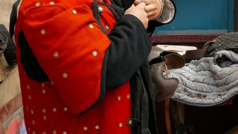 Man putting on thick fabric lining for armor 스톡 동영상 123583767