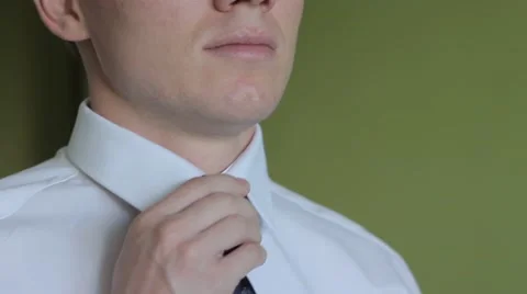 Man putting on tie clip, closeup, focused on clip Stock Footage 54445342