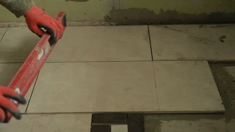 A man putting tiles on floor Stock Footage 88615582