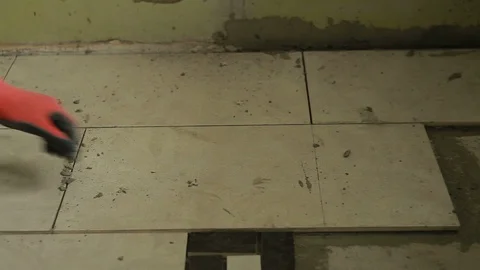 A man putting tiles on floor Stockbeeldmateriaal 94305870