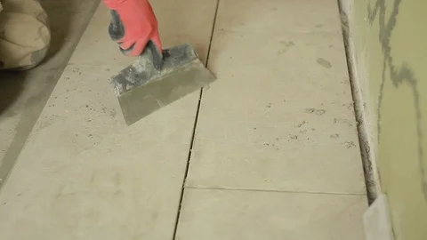 A man putting tiles on floor Stock Footage 94422849