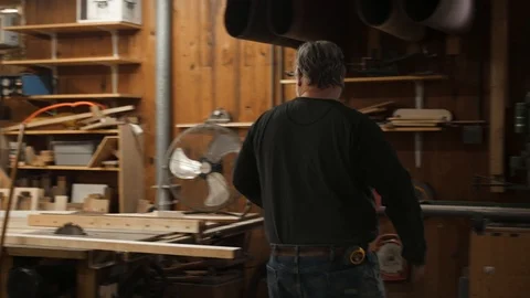 Man putting tool away on rack in woodworking shop Stock Footage 102045023