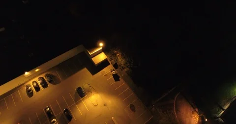 Man Putting Trash In Garbage In Parking Lot At Night Aerial Stock Footage 92490642