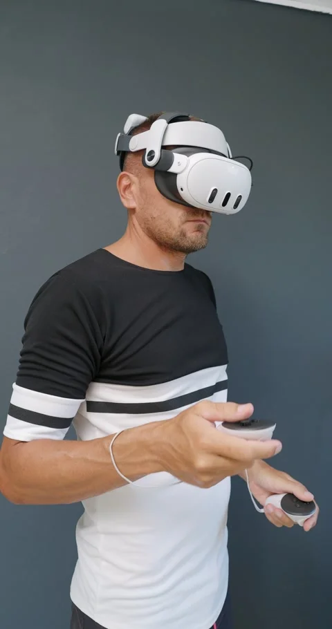 Man putting on Virtual Reality headset and experiencing mixed virtual reality. Stock Footage 257612624
