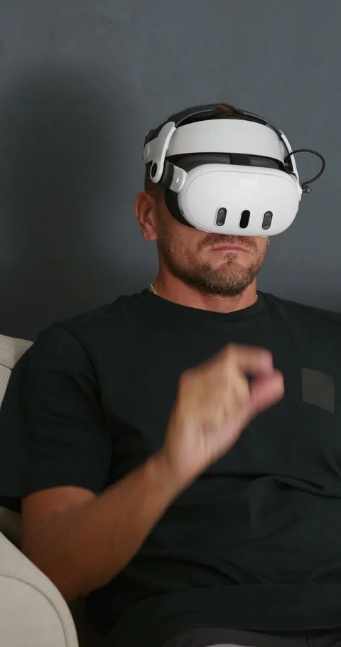 Man putting on Virtual Reality headset and experiencing mixed reality. Stock Footage 257993607