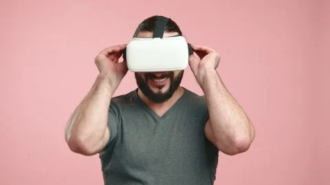 Man Putting on VR Headset to Dive into Virtual Reality Experience Stock Footage 265601171