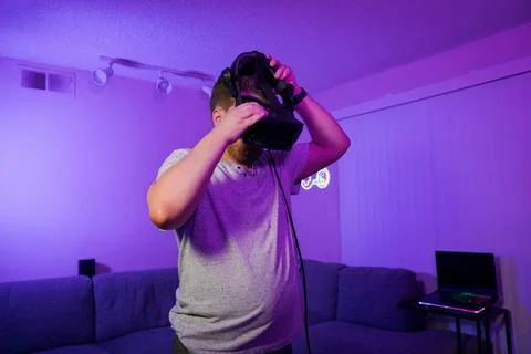 Man putting on VR headset before virtual gaming Stock Photos
