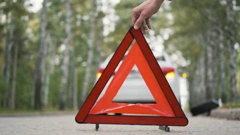 Man Putting Warning Triangle by the Broken Car Stock Footage 160266217