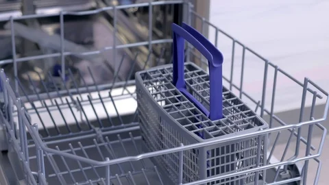 Man putting white utensil and cutlery in basket of dishwasher and close it. Stock Footage 116372953