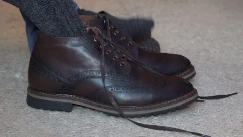 Man putting on winter boots Stock Footage 172424801