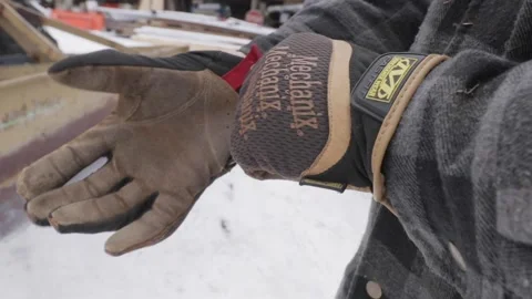 A man putting on Winter work gloves Stock Footage 141349867