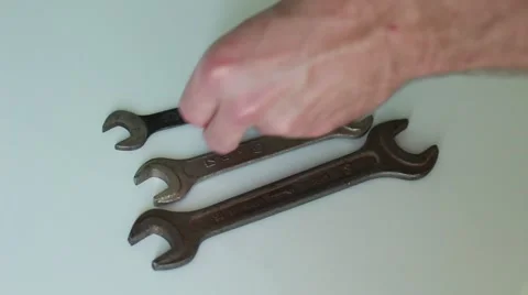 Man putting wrenchs on white surface Stock-Footage 65371188