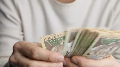 A man quickly counts bills of 500 hryvnia Stock Footage 128958349
