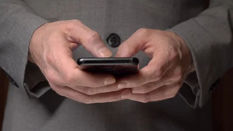 A man quickly prints a message on his smartphone. We see only his hands. Stock Footage 125252708