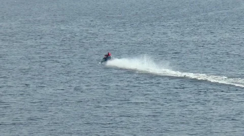 The man quickly swims on a snowmobile on water. Stock-Footage 67046818