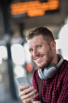 Man At Railway Station Using Mobile Phone On Platform Stock Photos