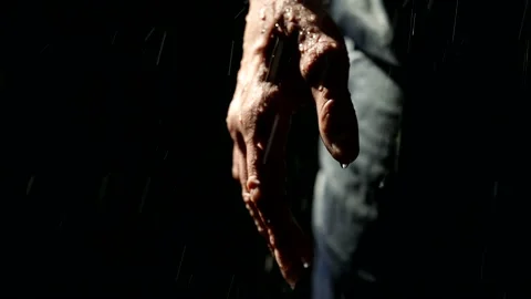 Man in rain in night, closeup view hand and leg in dark pants, drops are falling Stock Footage 205005573