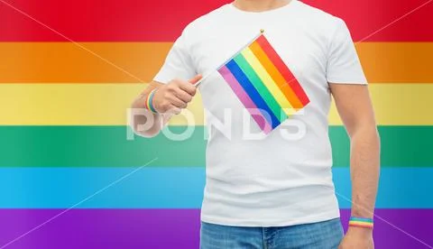 Man with rainbow flag and gay pride wristbands Stock Photos