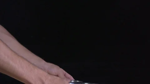 Man raise the colander from which drops of water drip. Super slow motion Stock Footage 80548573