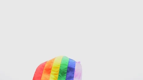 Man raise rainbow flag in hard wind Stock Footage 92407873