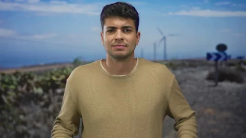 Man raises arms and does a shrug in outdoor shot where young hispanic guy l.. Stock Footage 310985020