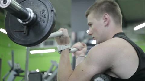 The man raises the bar in the gym 스톡 동영상 66574586