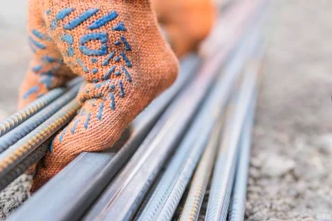 Man raises a bundle of reinforcement Stock Photos