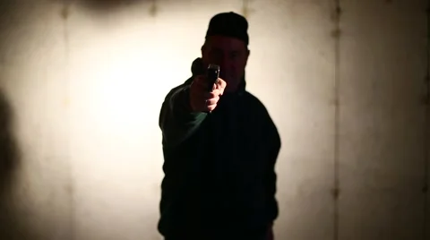 MAN RAISES GUN AND POINTS IT AT YOU Stock Footage 58130465