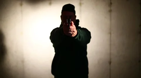 MAN RAISES GUN AND POINTS IT DIRECTLY AT YOU Stock Footage 58130468