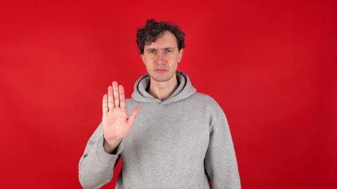 Man raises hand, palm forward, showing front sign stop, ban, rejected gesture 库存影片 304749208