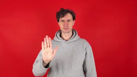 Man raises hand, palm forward, showing in front sign stop Stock Footage 304749210